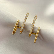Gold double hoop earrings with crystals, perfect for jewelry websites, jewelry storage, diamond and jewelry collections, and pairing with mature women hairstyles.