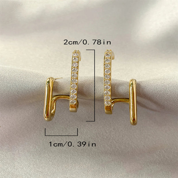 Gold double hoop earrings with crystals, perfect for jewelry websites, jewelry storage, diamond and jewelry collections, and pairing with mature women hairstyles.