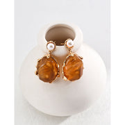 Gold drop earrings with amber stones and pearls, perfect for vintage jewelry lovers, jewelry designers, and jewelry storage ideas on top jewelry websites.