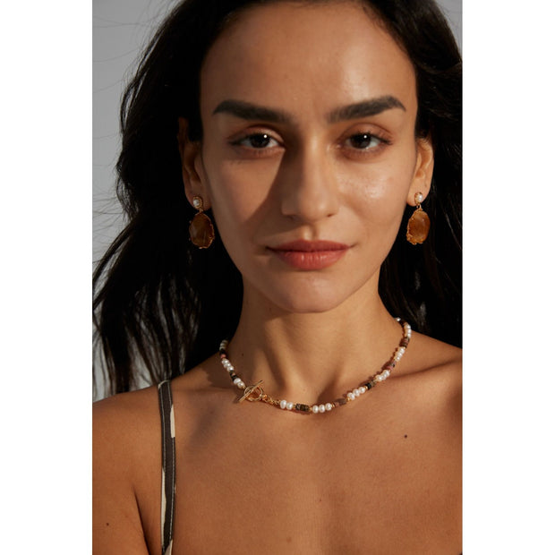 Gold drop earrings with amber stones and pearls, perfect for vintage jewelry lovers, jewelry designers, and jewelry storage ideas on top jewelry websites.