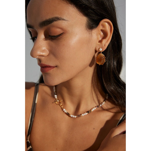 Gold drop earrings with amber stones and pearls, perfect for vintage jewelry lovers, jewelry designers, and jewelry storage ideas on top jewelry websites.