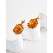 Gold drop earrings with amber stones and pearls, perfect for vintage jewelry lovers, jewelry designers, and jewelry storage ideas on top jewelry websites.