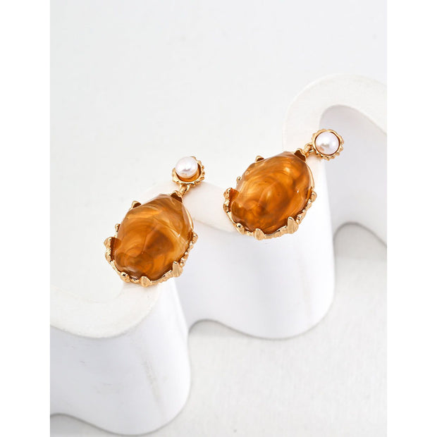 Gold drop earrings with amber stones and pearls, perfect for vintage jewelry lovers, jewelry designers, and jewelry storage ideas on top jewelry websites.