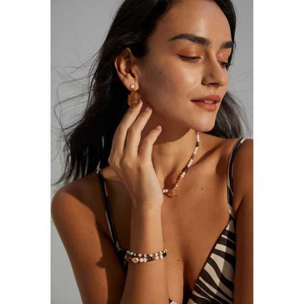 Gold drop earrings with amber stones and pearls, perfect for vintage jewelry lovers, jewelry designers, and jewelry storage ideas on top jewelry websites.