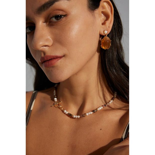 Gold drop earrings with amber stones and pearls, perfect for vintage jewelry lovers, jewelry designers, and jewelry storage ideas on top jewelry websites.