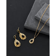Gold drop earrings with black stones and sunburst design, perfect for jewelry storage, vintage jewelry collections, jewelry websites, and stylish gifting.