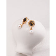 Gold drop earrings with tiger eye gemstones and pearl accents, perfect for vintage jewelry, jewelry storage, jewelry websites, and elegant jewelry for mom.
