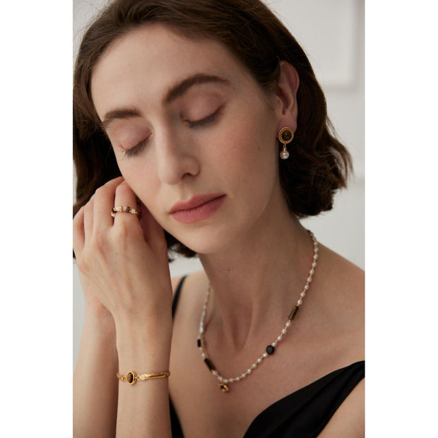 Gold drop earrings with tiger eye gemstones and pearl accents, perfect for vintage jewelry, jewelry storage, jewelry websites, and elegant jewelry for mom.