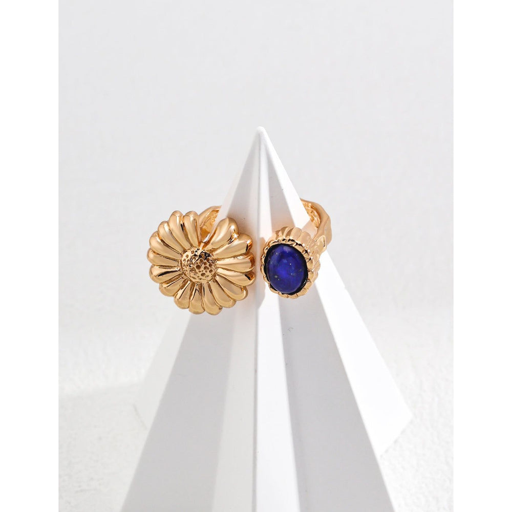 Elegant gold flower and blue gemstone rings on display – perfect for jewelry storage, designed by leading jewelry designers. Great addition to vintage jewelry collections, earrings rings sets, and jewelry with turquoise. Explore diamond and jewelry trends, body jewelry plus accessories, and name of jewelry stones for your personal or gift needs.