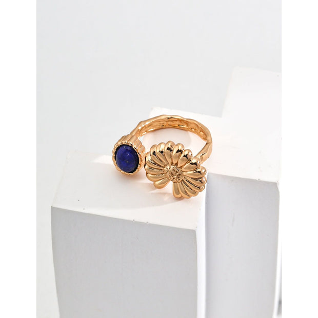 Elegant gold flower and blue gemstone rings on display – perfect for jewelry storage, designed by leading jewelry designers. Great addition to vintage jewelry collections, earrings rings sets, and jewelry with turquoise. Explore diamond and jewelry trends, body jewelry plus accessories, and name of jewelry stones for your personal or gift needs.