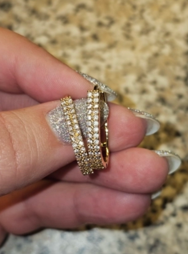 Gold hoop earrings with shimmering crystals, perfect for jewelry websites, jewelry storage, diamond and jewelry collections, and elegant gift ideas.