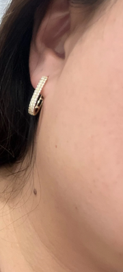 Gold hoop earrings with shimmering crystals, perfect for jewelry websites, jewelry storage, diamond and jewelry collections, and elegant gift ideas.