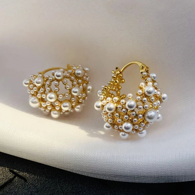 Gold hoop earrings adorned with cascading pearls, perfect for jewelry websites, jewelry storage, vintage jewelry, and gifting for mom or elegant occasions.