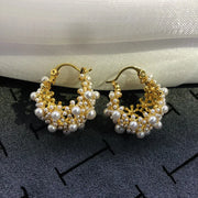 Gold hoop earrings adorned with cascading pearls, perfect for jewelry websites, jewelry storage, vintage jewelry, and gifting for mom or elegant occasions.
