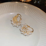 Gold hoop earrings adorned with cascading pearls, perfect for jewelry websites, jewelry storage, vintage jewelry, and gifting for mom or elegant occasions.