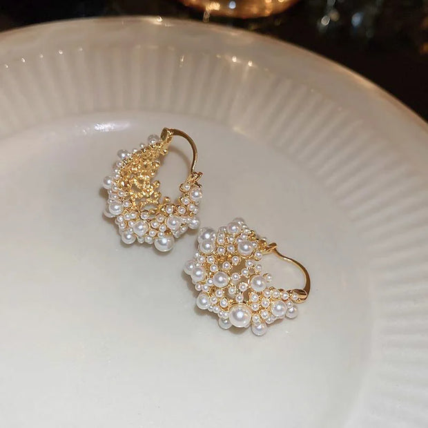Gold hoop earrings adorned with cascading pearls, perfect for jewelry websites, jewelry storage, vintage jewelry, and gifting for mom or elegant occasions.