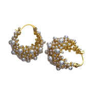 Gold hoop earrings adorned with cascading pearls, perfect for jewelry websites, jewelry storage, vintage jewelry, and gifting for mom or elegant occasions.