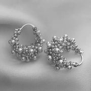 Gold hoop earrings adorned with cascading pearls, perfect for jewelry websites, jewelry storage, vintage jewelry, and gifting for mom or elegant occasions.