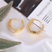 Gold hoop earrings with sparkling crystals and filigree design, perfect for jewelry websites, jewelry storage, vintage jewelry, and gifting for mom.