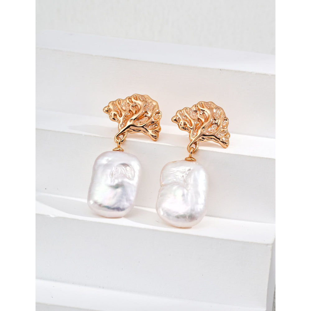 Gold leaf and pearl drop earrings perfect for jewelry storage, crafted by expert jewelry designers. Ideal for vintage jewelry lovers, earrings piercing, and unique jewelry brands.