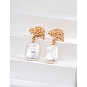 Gold leaf and pearl drop earrings perfect for jewelry storage, crafted by expert jewelry designers. Ideal for vintage jewelry lovers, earrings piercing, and unique jewelry brands.