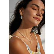 Gold leaf and pearl drop earrings perfect for jewelry storage, crafted by expert jewelry designers. Ideal for vintage jewelry lovers, earrings piercing, and unique jewelry brands.