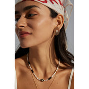 Gold oval pearl earrings with intricate lattice design on a white surface, ideal for vintage jewelry lovers, jewelry websites, and jewelry storage ideas. A perfect accessory for mature women hairstyles, earrings rings combinations, and showcasing gem jewelry or diamond and jewelry pieces.