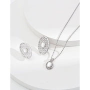 Gold oval pearl earrings with intricate lattice design on a white surface, ideal for vintage jewelry lovers, jewelry websites, and jewelry storage ideas. A perfect accessory for mature women hairstyles, earrings rings combinations, and showcasing gem jewelry or diamond and jewelry pieces.