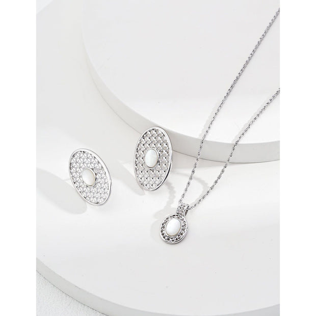 Gold oval pearl earrings with intricate lattice design on a white surface, ideal for vintage jewelry lovers, jewelry websites, and jewelry storage ideas. A perfect accessory for mature women hairstyles, earrings rings combinations, and showcasing gem jewelry or diamond and jewelry pieces.