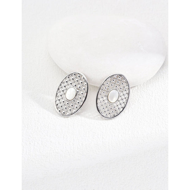 Gold oval pearl earrings with intricate lattice design on a white surface, ideal for vintage jewelry lovers, jewelry websites, and jewelry storage ideas. A perfect accessory for mature women hairstyles, earrings rings combinations, and showcasing gem jewelry or diamond and jewelry pieces.
