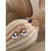 Elegant gold-tone earrings with pearls and navy beads, perfect for vintage jewelry enthusiasts, jewelry designers, and fans of earrings rings and piercing styles.