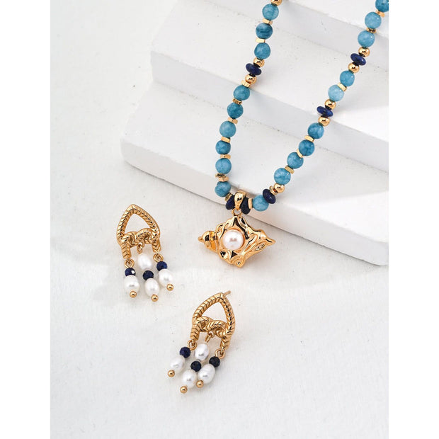 Elegant gold-tone earrings with pearls and navy beads, perfect for vintage jewelry enthusiasts, jewelry designers, and fans of earrings rings and piercing styles.
