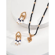 Elegant gold-tone earrings with pearls and navy beads, perfect for vintage jewelry enthusiasts, jewelry designers, and fans of earrings rings and piercing styles.