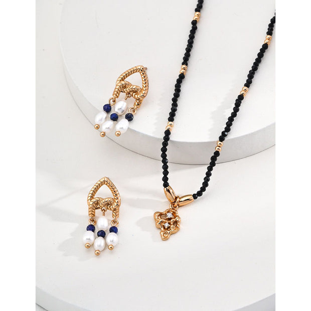 Elegant gold-tone earrings with pearls and navy beads, perfect for vintage jewelry enthusiasts, jewelry designers, and fans of earrings rings and piercing styles.