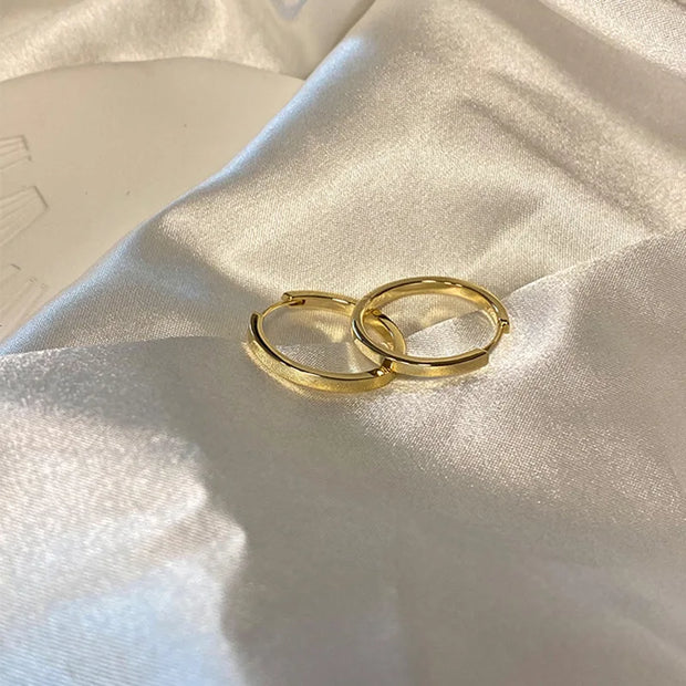 Gold hoop earrings with delicate pearls, ideal for jewelry storage, jewelry cleaning, and showcasing on jewelry websites by top jewelry designers for timeless style.