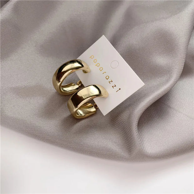 Gold hoop earrings with delicate pearls, ideal for jewelry storage, jewelry cleaning, and showcasing on jewelry websites by top jewelry designers for timeless style.