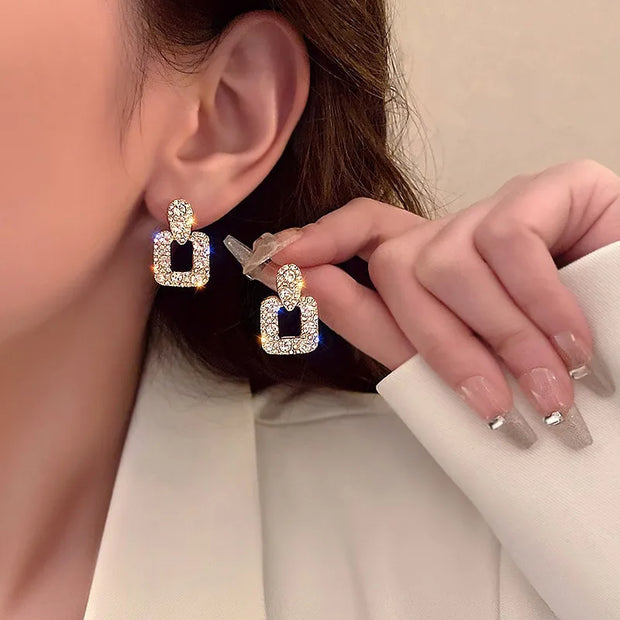 Gold hoop earrings with delicate pearls, ideal for jewelry storage, jewelry cleaning, and showcasing on jewelry websites by top jewelry designers for timeless style.