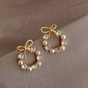 Gold hoop earrings with delicate pearls, ideal for jewelry storage, jewelry cleaning, and showcasing on jewelry websites by top jewelry designers for timeless style.