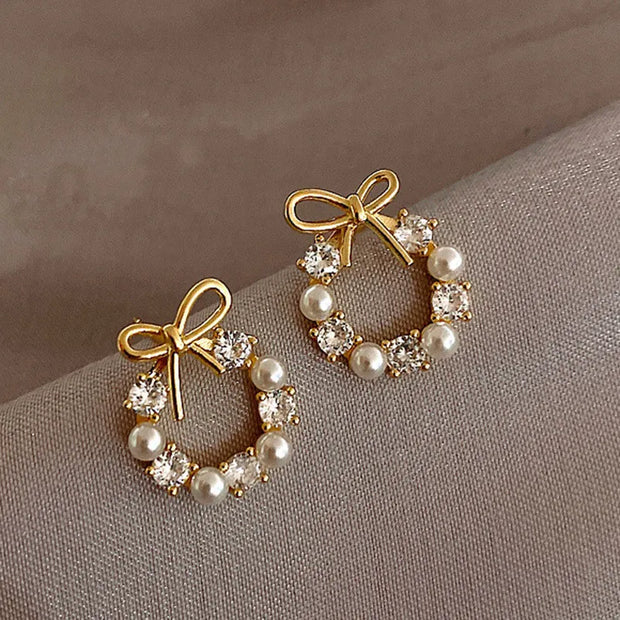 Gold hoop earrings with delicate pearls, ideal for jewelry storage, jewelry cleaning, and showcasing on jewelry websites by top jewelry designers for timeless style.