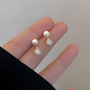 Gold hoop earrings with delicate pearls, ideal for jewelry storage, jewelry cleaning, and showcasing on jewelry websites by top jewelry designers for timeless style.