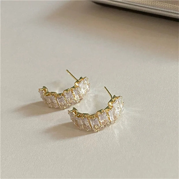 Gold hoop earrings with delicate pearls, ideal for jewelry storage, jewelry cleaning, and showcasing on jewelry websites by top jewelry designers for timeless style.