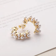 Gold hoop earrings with delicate pearls, ideal for jewelry storage, jewelry cleaning, and showcasing on jewelry websites by top jewelry designers for timeless style.