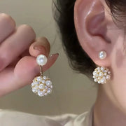 Gold hoop earrings with delicate pearls, ideal for jewelry storage, jewelry cleaning, and showcasing on jewelry websites by top jewelry designers for timeless style.