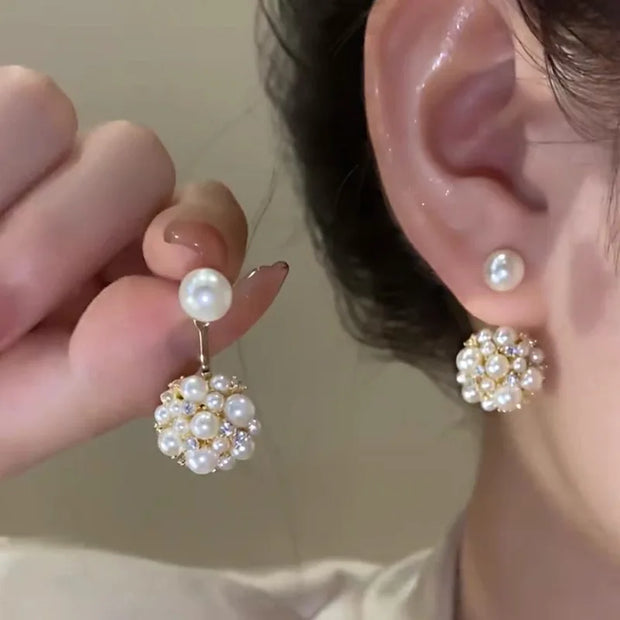 Gold hoop earrings with delicate pearls, ideal for jewelry storage, jewelry cleaning, and showcasing on jewelry websites by top jewelry designers for timeless style.