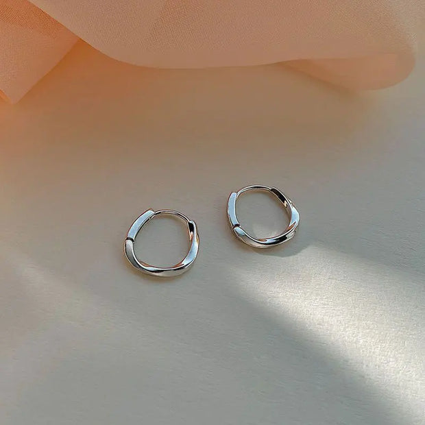 Gold hoop earrings with delicate pearls, ideal for jewelry storage, jewelry cleaning, and showcasing on jewelry websites by top jewelry designers for timeless style.