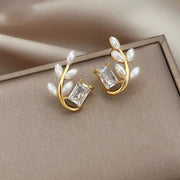 Gold hoop earrings with delicate pearls, ideal for jewelry storage, jewelry cleaning, and showcasing on jewelry websites by top jewelry designers for timeless style.