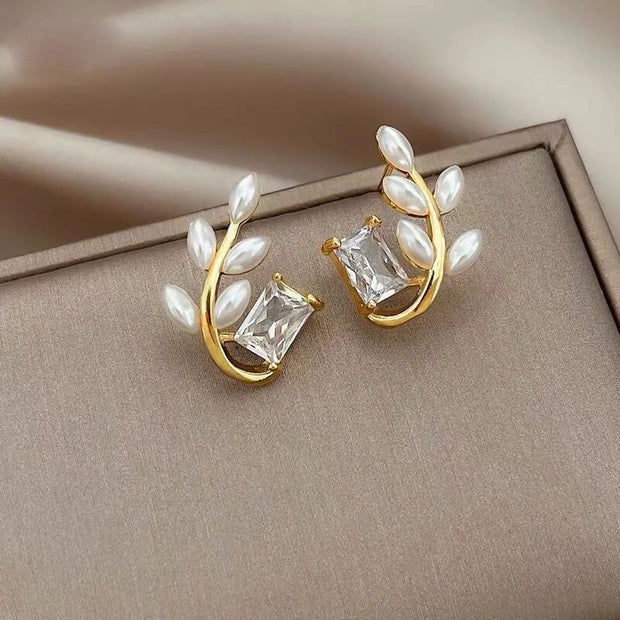 Gold hoop earrings with delicate pearls, ideal for jewelry storage, jewelry cleaning, and showcasing on jewelry websites by top jewelry designers for timeless style.