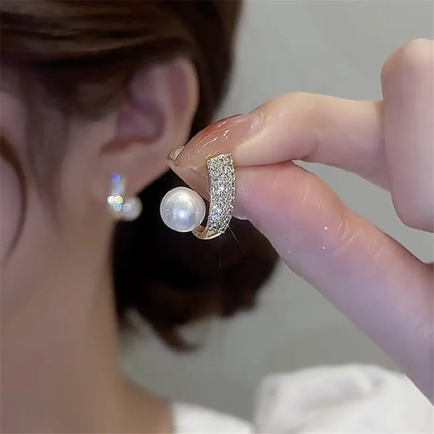 Gold hoop earrings with delicate pearls, ideal for jewelry storage, jewelry cleaning, and showcasing on jewelry websites by top jewelry designers for timeless style.
