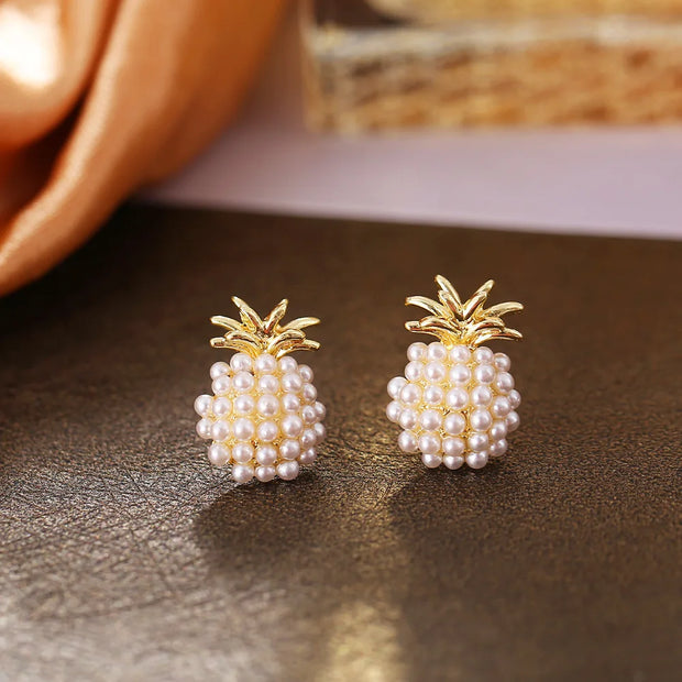 Gold hoop earrings with delicate pearls, ideal for jewelry storage, jewelry cleaning, and showcasing on jewelry websites by top jewelry designers for timeless style.