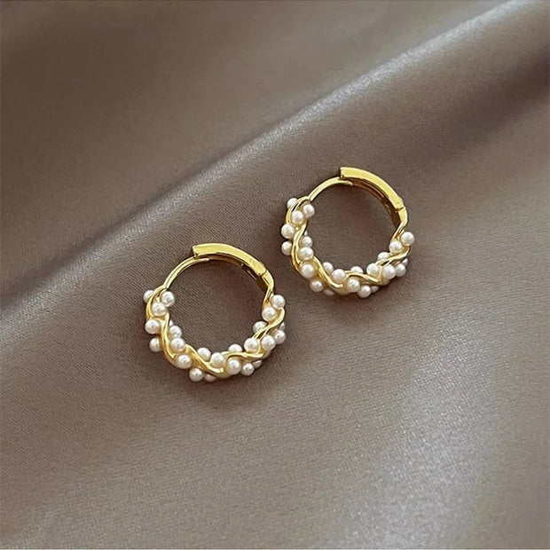 Gold hoop earrings with delicate pearls, ideal for jewelry storage, jewelry cleaning, and showcasing on jewelry websites by top jewelry designers for timeless style.